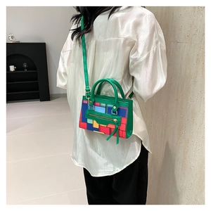 Vibrant geometric patchwork mini handbag in retro green PU leather with top handle