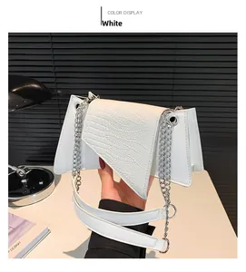 Detail of white stone-pattern handbag with geometric flap and silver chain strap