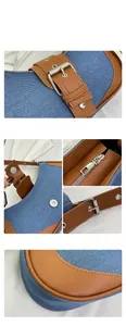Detailed shot of stitching on blue denim and brown leather patchwork shoulder bag
