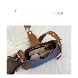 Interior view of denim and leather hobo bag showing large storage capacity and compartments