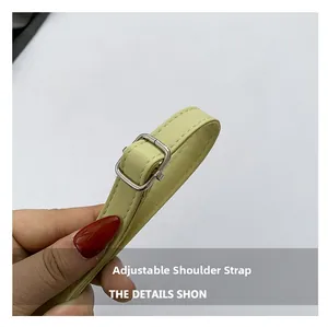 Detail of adjustable pale green leather strap with silver buckle and fine stitching