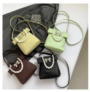 Mini bow pearl handbags in yellow, green, brown, and black colors for women
