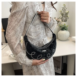 Detail of black crescent hobo bag with white contrast stitching and floral embroidery