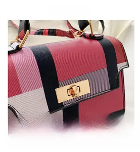 Close-up of colorful checkered handbag featuring premium crosshatch texture and gold lock
