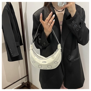 White hobo shoulder bag with black embroidered heart pattern for modern women