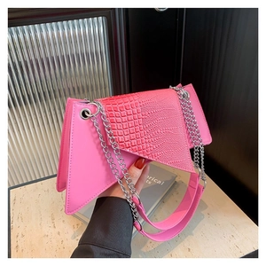 Pink asymmetrical crocodile embossed handbag with silver chain and wide shoulder strap