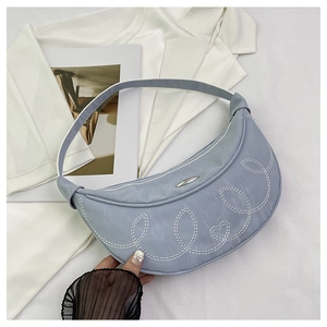 Detail of light blue crescent bag with white contrast stitching and silver metal buckle