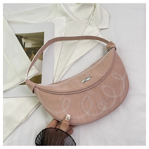 Detailed embroidery and silver buckle on a pink crescent saddle bag for women