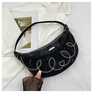 Chic black crescent moon shoulder bag with contrast heart stitching and silver buckle