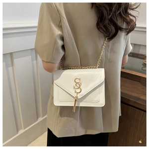 White leather crossbody bag with gold chain strap and tassel detail for women's daily wear