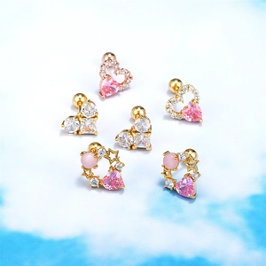 Detailed view of 18K gold-plated heart-shaped stud earrings set with pink cubic zirconia