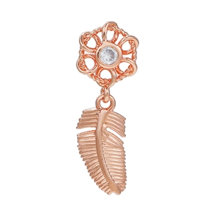 Detailed close-up of rose gold feather drop earring with crystal floral stud detail