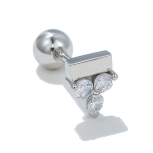 Macro detail of silver geometric earring featuring clear zircons and secure screw back