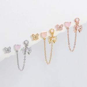 Set de boucles d'oreilles cœur rose et papillon en finitions argent or et rose