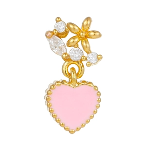 Detail of a pink enamel heart earring with gold flower and sparkling cubic zirconia