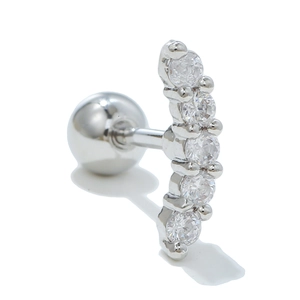 Macro shot of curved stainless steel helix earring with five clear cubic zirconia studs
