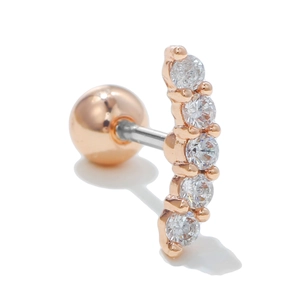 Macro shot of rose gold surgical steel ear stud with curved clear zircon inlay and screw ball back