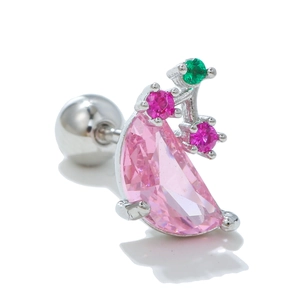 Detailed macro view of silver steel cartilage stud with pink crescent and green zircon