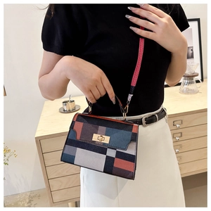 Detail of colorful plaid crossbody bag with gold twist lock and adjustable shoulder strap