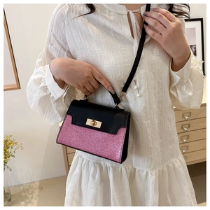 Detailed view of women's mini crossbody bag with pink glitter and black flap