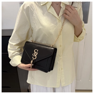 Elegant black leather square bag with gold chain strap and tassel detail for women