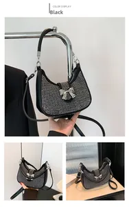 Detail of black rhinestone shoulder bag with metal bow buckle and silver hardware zip