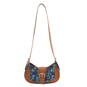 Retro denim crescent shoulder bag with brown leather trim and adjustable silver buckle strap