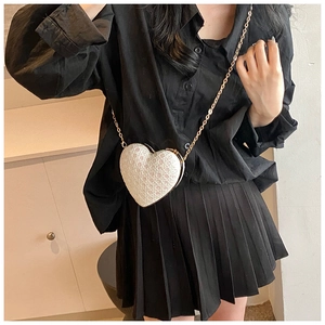 Mini heart-shaped crossbody bag with white pearl sequins and golden chain strap