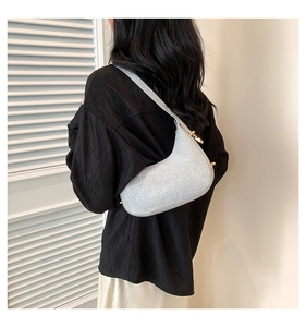 Silver sequin crescent shoulder bag with gold hardware shown on model for daily style