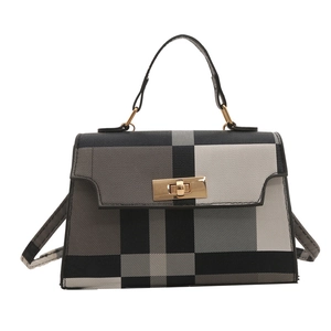 Classic checkered crossbody bag with top handle and gold rotating lock in grey and white