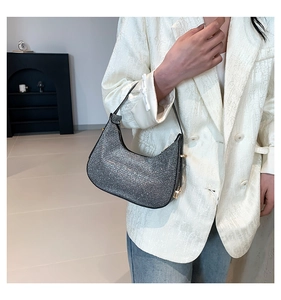 Sparkling silver rhinestone baguette bag styled with a white blazer and denim jeans