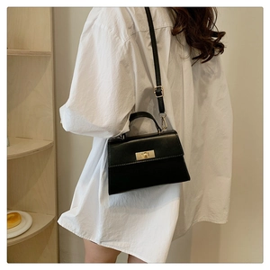 Classic black leather-style crossbody square bag with gold metal buckle and top handle