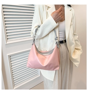 Detail of pink satin hobo bag with silver Fashion lettering and metallic handle
