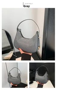 Macro detail of the sparkling grey crescent saddle bag with metallic sequins and zipper
