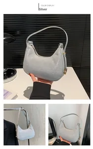 Detail of silver sequined hobo bag with metallic shoulder strap and shimmering texture