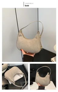 Detail showing metallic gold hobo bag with glitter texture and smooth zipper closure