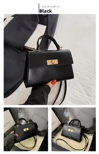 Detail of black leather Kelly-style bag with gold twist-lock in premium gift box