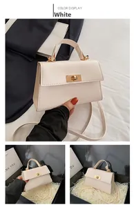 Detail of off-white Kelly style handbag with gold lock and sleek leather texture
