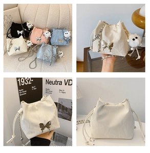 Detail view of drawstring bucket bags with butterfly buckles and plush charms