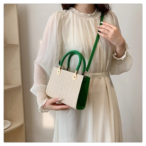 Woven straw crossbody bag with green leather trim and V-pattern texture for women