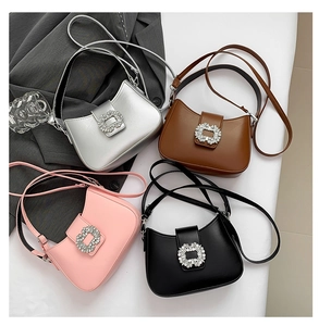 Close-up of four minimalist underarm bags with sparkling rhinestone buckles in multiple colors