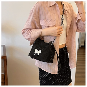 Black drawstring bucket bag with white butterfly print and metal chain strap