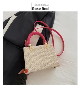 Close-up of rose red woven handles and textured straw weave on summer tote bag