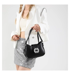 Detail of elegant black PU crossbody bag featuring a sparkling square rhinestone buckle