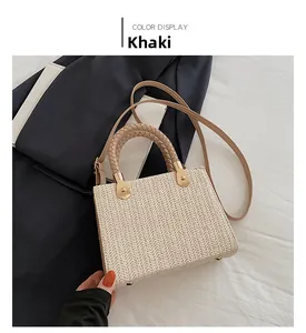 Macro shot of the khaki woven handbag featuring herringbone texture and gold base feet