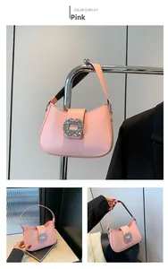 Detail of pink leather underarm bag featuring a luxury square rhinestone buckle and strap