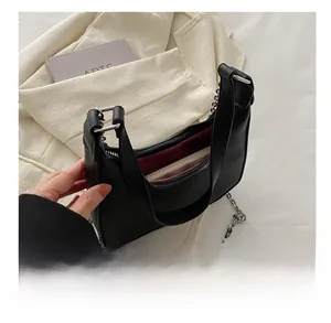 Top view of black pebbled leather saddle bag showing interior space and red lining
