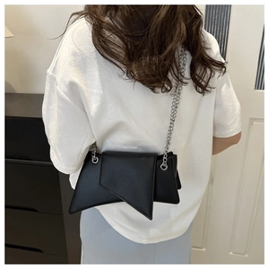 Unique geometric crossbody bag in black with silver chain strap shown on model back