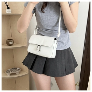 Minimalist creamy white crossbody square bag with silver horseshoe buckle on a model
