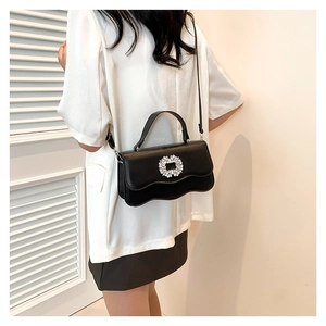 Elegant black rhinestone buckle shoulder bag with wavy edge design and top handle
